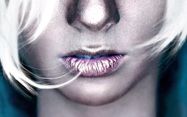 HD wallpaper featuring a close-up of a woman's lips with a metallic sheen, framed by light strands of hair, creating a striking visual contrast against a soft background.