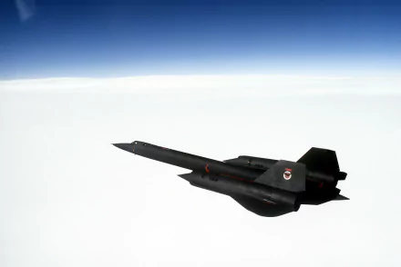 HD desktop wallpaper featuring a Lockheed SR-71 Blackbird military aircraft flying above the clouds against a clear blue sky.