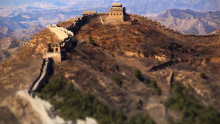A stunning 4K Ultra HD image of the Great Wall of China winding through mountainous terrain, showcasing the remarkable man-made structure against a serene backdrop.
