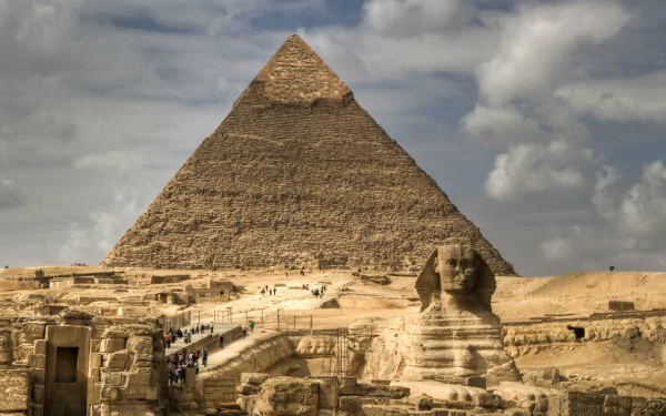 A stunning HD image of the Great Pyramid of Giza, showcasing its grandeur alongside the Sphinx, with dramatic skies enhancing the iconic Egyptian landscape.