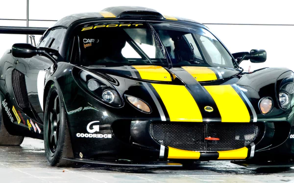 Black Lotus Exige sports car with bold yellow racing stripes, showcased as an HD PC desktop wallpaper and background.