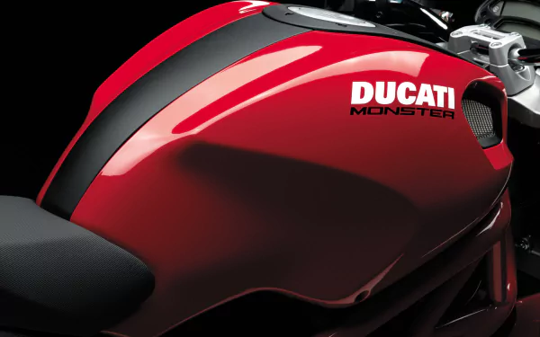 Close-up of a red Ducati Monster motorcycle tank, featured as a high-definition PC desktop wallpaper and background.