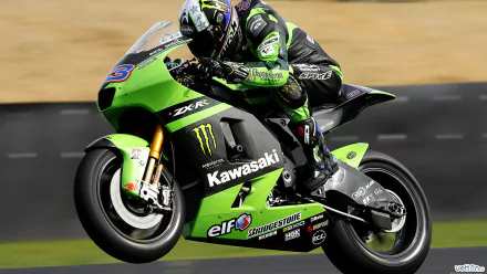 HD PC desktop wallpaper featuring a Kawasaki Ninja motorcycle in action on the track, showcasing its sleek green design and racing decals.