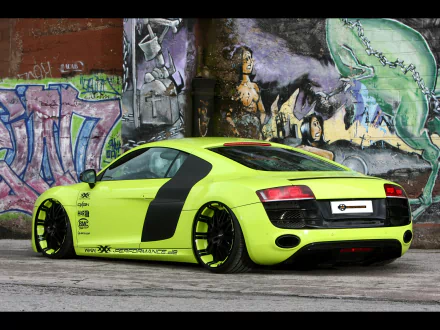 A striking Audi R8 in vibrant green, showcased against a colorful graffiti backdrop, serves as an eye-catching HD desktop wallpaper.