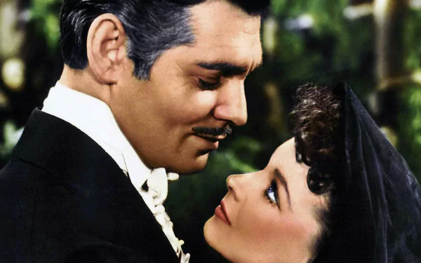 HD desktop wallpaper featuring a romantic close-up scene from the movie Gone With The Wind, showcasing the iconic characters in vintage attire.