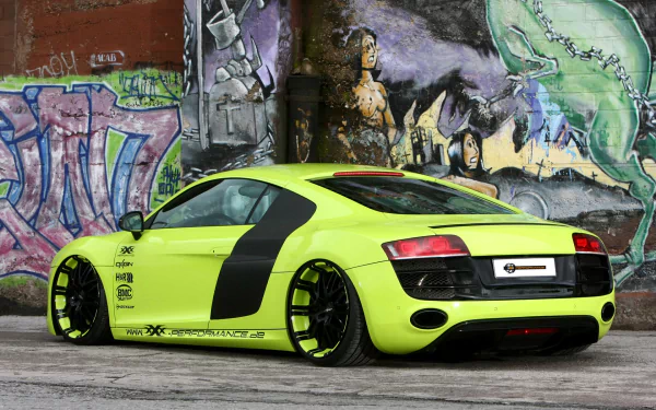 A striking Audi R8 in vibrant green, showcased against a colorful graffiti backdrop, serves as an eye-catching HD desktop wallpaper.