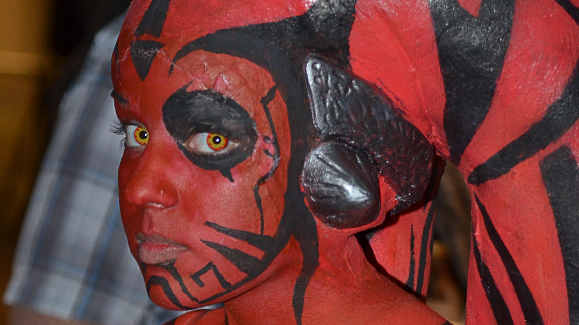 HD PC desktop wallpaper featuring a woman cosplaying as Darth Talon from Star Wars with detailed red and black face and body paint.