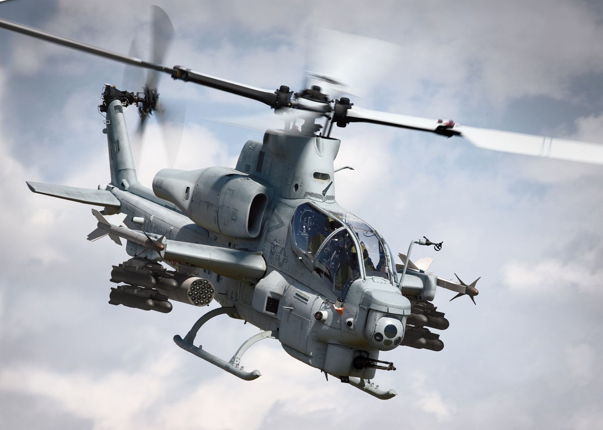 A Bell AH-1Z Viper helicopter in action, showcasing its military capabilities with armaments visible. This HD image serves as a striking desktop wallpaper or background.