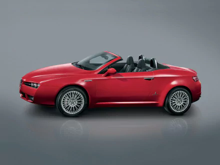 HD desktop wallpaper featuring a sleek red Alfa Romeo Brera Spider convertible against a neutral gray background.