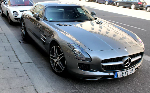 Silver Mercedes-Benz SLS AMG parked on a city street, captured in sharp detail for a 4K Ultra HD PC desktop wallpaper.