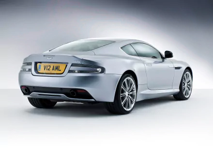 Silver Aston Martin DB9 vehicle, rear three-quarter studio shot on a soft gradient backdrop — HD PC desktop wallpaper background