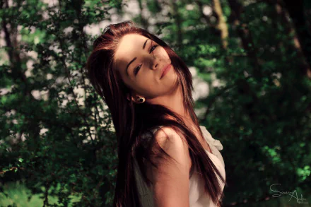 A close-up of a woman with long hair smiling softly in a sunlit forest, captured in 4K Ultra HD for use as a PC desktop wallpaper and background.