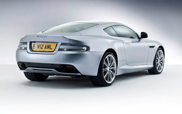 Silver Aston Martin DB9 vehicle, rear three-quarter studio shot on a soft gradient backdrop — HD PC desktop wallpaper background