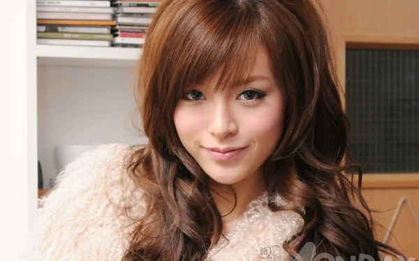 HD PC desktop wallpaper and background: close-up of a smiling female celebrity with long brown hair wearing a fuzzy sweater in a cozy indoor setting.