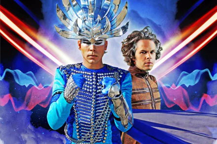 HD PC desktop wallpaper: music-themed Empire Of The Sun artwork featuring two flamboyant sci‑fi costumed figures amid neon beams and cosmic wave patterns.