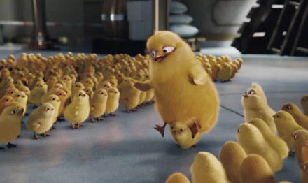 HD PC desktop wallpaper and background from the movie Hop: a large fluffy yellow chick steps among dozens of smaller chicks on a bright factory floor.