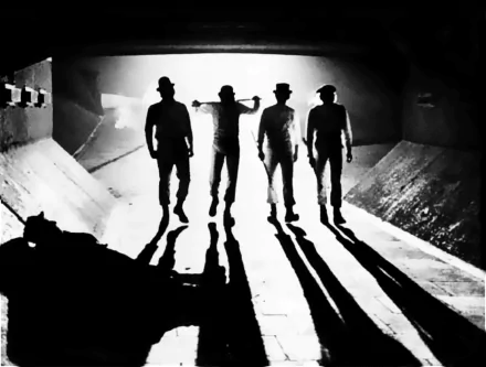 HD PC desktop wallpaper featuring a striking black-and-white scene from the movie A Clockwork Orange, showing four silhouetted figures walking in a tunnel.
