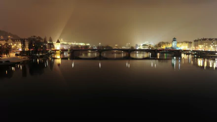 Night view of Prague, Czech Republic: illuminated man-made bridges and historic riverside buildings reflected on the Vltava — 4K Ultra HD PC desktop wallpaper/background