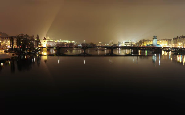 Night view of Prague, Czech Republic: illuminated man-made bridges and historic riverside buildings reflected on the Vltava — 4K Ultra HD PC desktop wallpaper/background