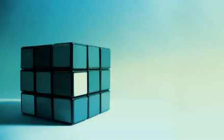 HD desktop wallpaper featuring a Rubik's Cube in shades of teal and blue on a gradient background.