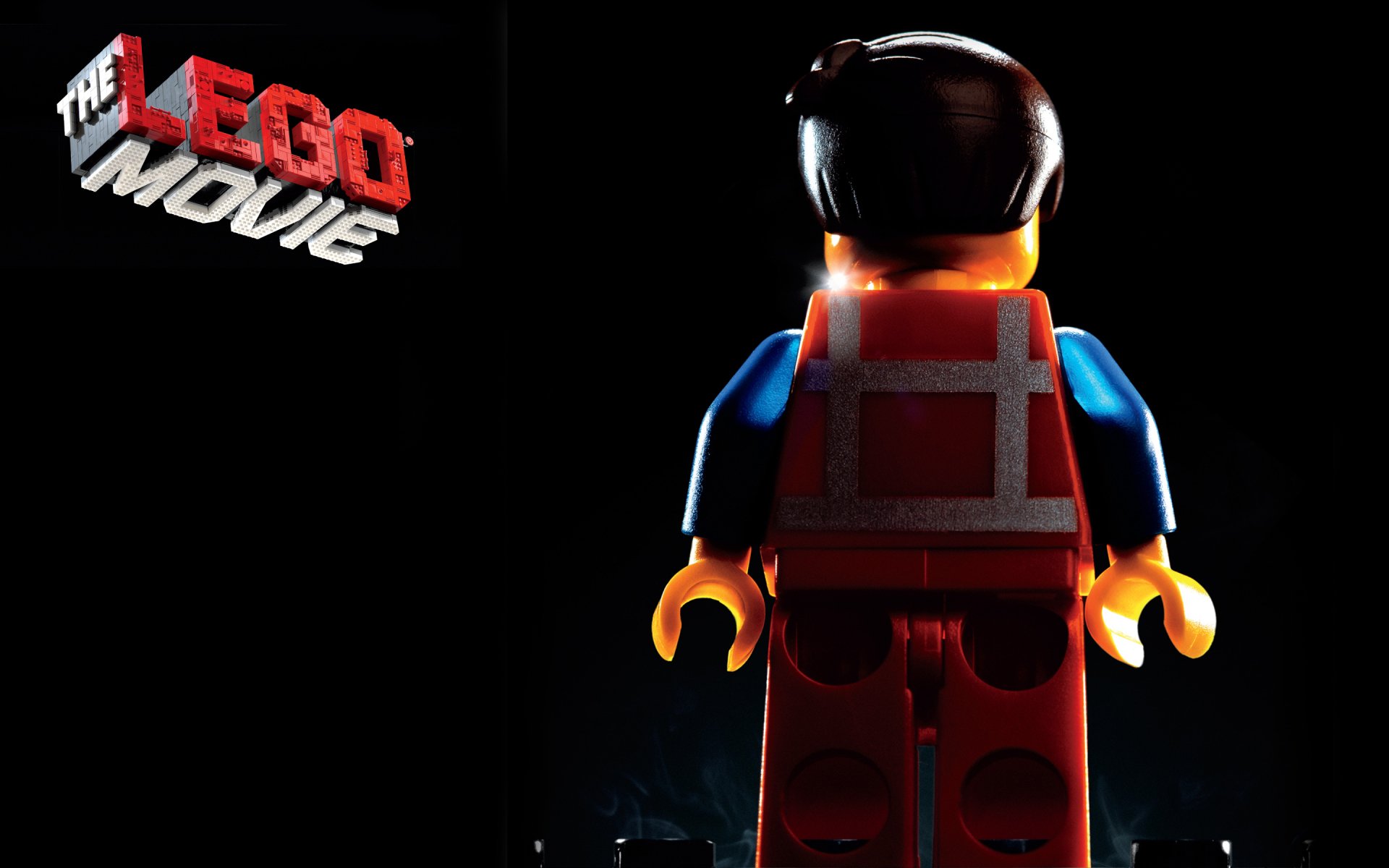 HD desktop wallpaper of Emmet from The Lego Movie with a dark background and the movie's logo on the top left.