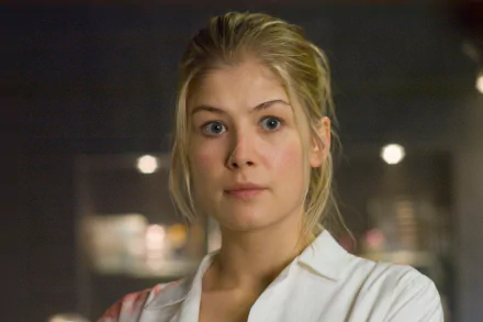 HD PC desktop wallpaper featuring Rosamund Pike from the movie Doom, showcasing a close-up of her character in a dimly lit setting.