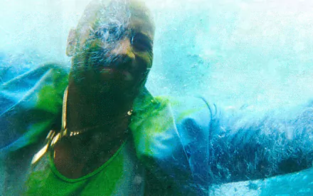 HD desktop wallpaper of Paul Doyle as portrayed by Dwayne Johnson in the movie Pain & Gain, featuring a dynamic underwater shot with vibrant blue tones.