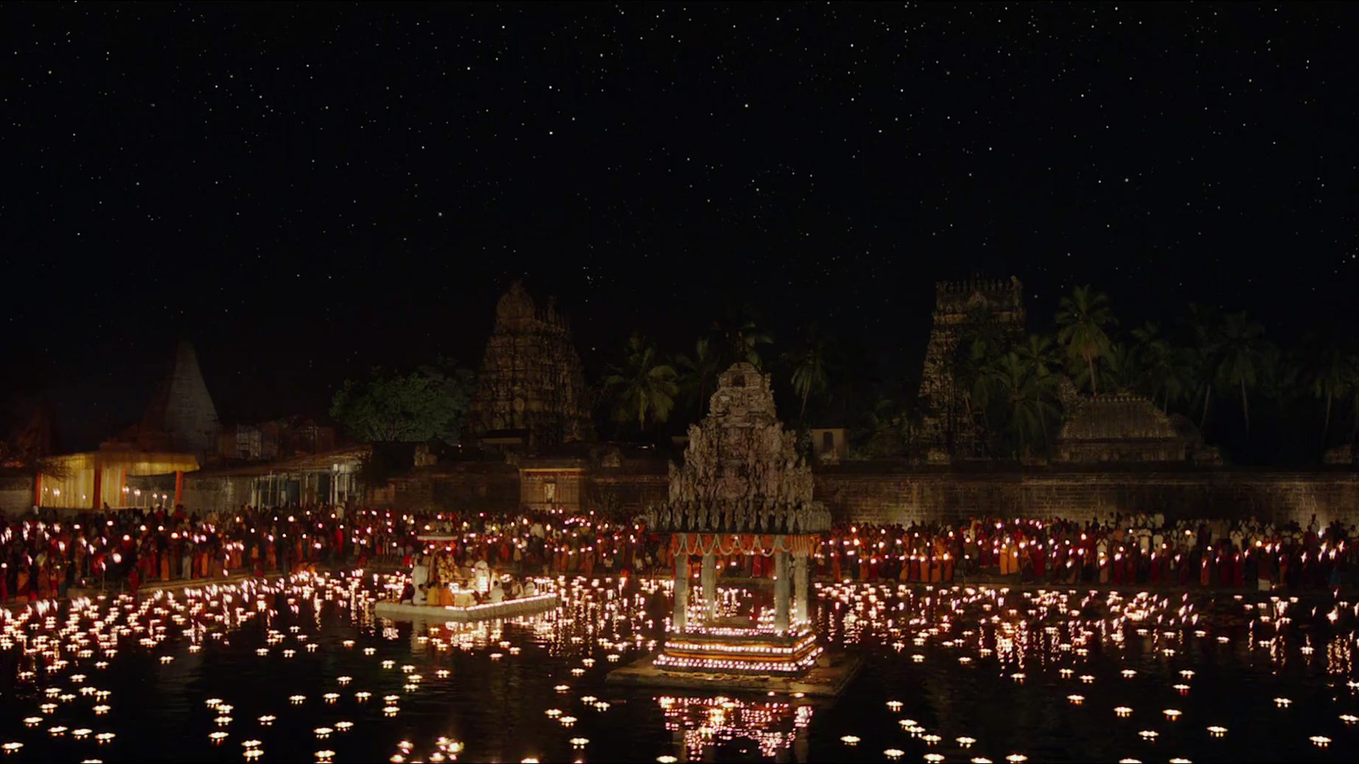 HD PC desktop wallpaper and background from the movie Life of Pi: a night temple scene lit by thousands of floating candles on water under a clear, starry sky.