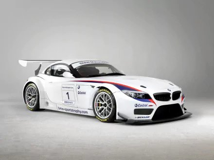 HD PC desktop wallpaper of a white BMW Z4 GT3 race vehicle — aerodynamic Z4 GT3 with blue-red stripes, sponsor decals and a large rear wing on a neutral background.