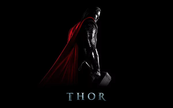 HD desktop wallpaper featuring Thor from the movie, standing against a dark background with a red cape and his hammer, Mjölnir, in hand. The word Thor is displayed at the bottom.