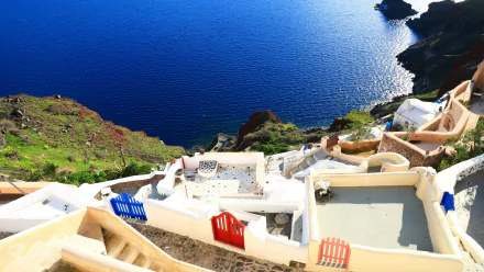 A stunning 4K Ultra HD view of Santorini, Greece, showcasing white man-made architecture overlooking the deep blue sea.
