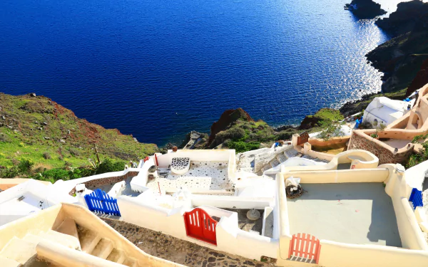 A stunning 4K Ultra HD view of Santorini, Greece, showcasing white man-made architecture overlooking the deep blue sea.