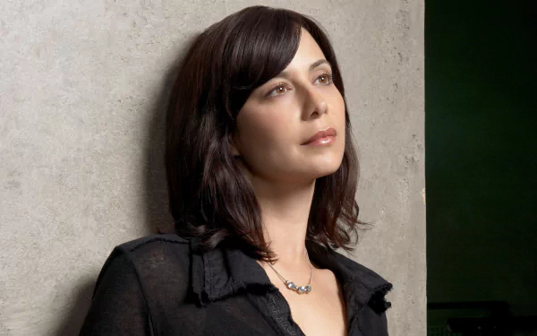 HD desktop wallpaper featuring British actress and celebrity Catherine Bell in a contemplative pose against a neutral background.