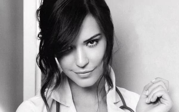 Black and white HD wallpaper featuring American actress Odette Annable, exuding confidence with a subtle smile and a stethoscope. A striking desktop background option.