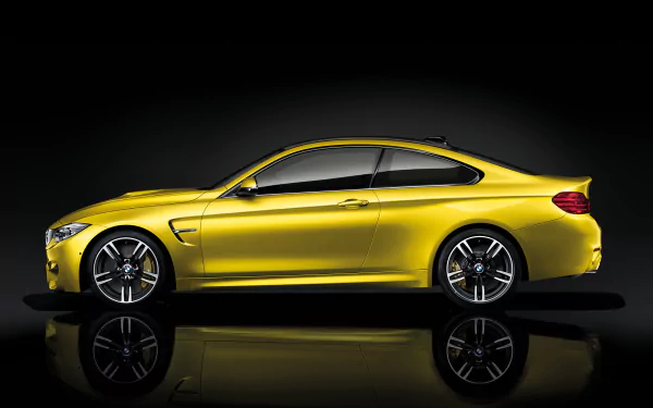 Side profile of a yellow BMW M4 Coupe reflected on a glossy black surface, 2K Quad HD PC desktop wallpaper/background of a BMW vehicle.