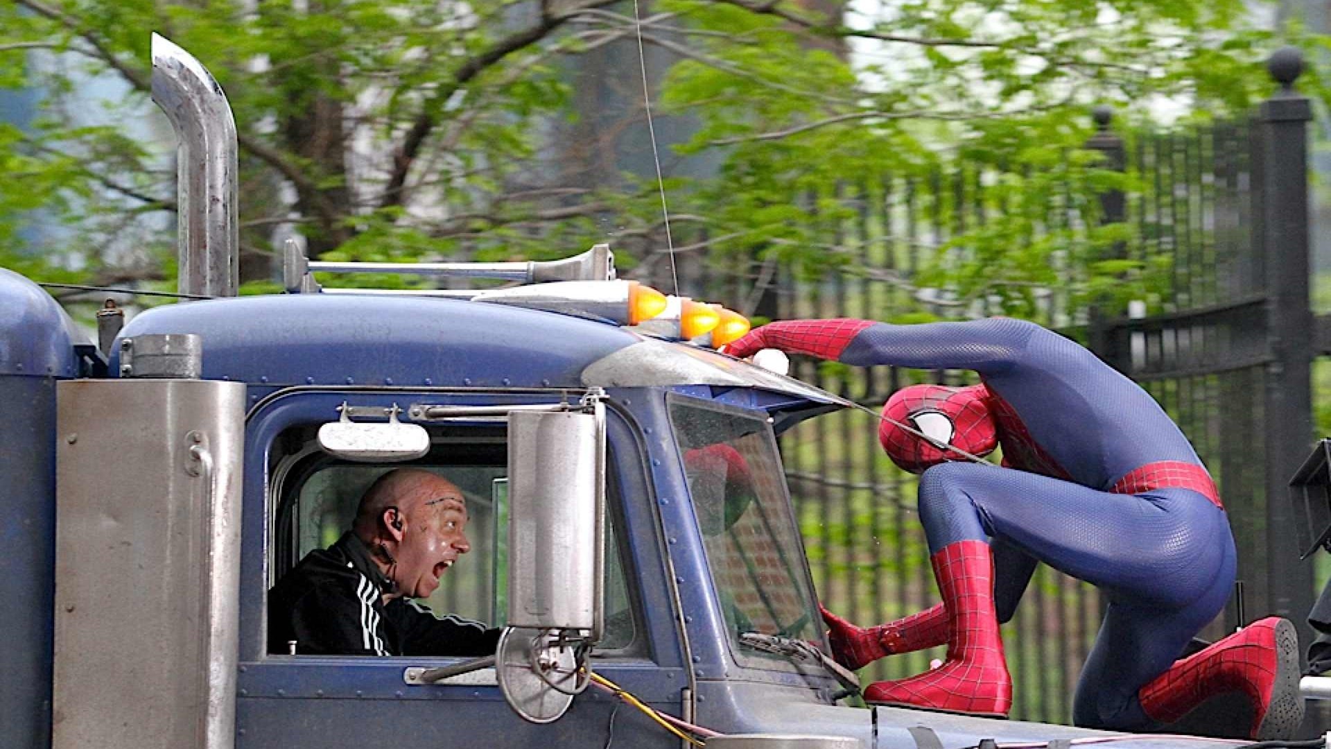 Spider-Man in an action pose on a truck, alarming the driver, from the movie The Amazing Spider-Man 2. HD desktop wallpaper and background.