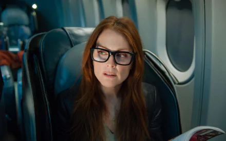 4K Ultra HD image of British actress Julianne Moore seated on a plane, featuring a scene from the movie Non-Stop.