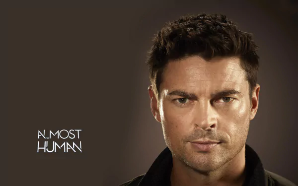 HD desktop wallpaper featuring a man with the title Almost Human emblazoned below him in a simple font.