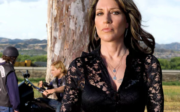 Portrait of a woman in a black lace top standing by motorcycles and riders in a rural landscape — Sons of Anarchy TV show 2K Quad HD PC desktop wallpaper.