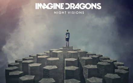 A striking HD wallpaper featuring a figure standing atop jagged pillars, with a dreamy sky backdrop and the text Imagine Dragons Night Visions prominently displayed.