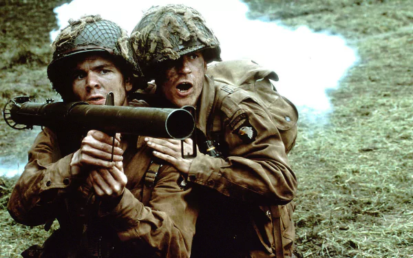 HD desktop wallpaper featuring soldiers from the TV show Band of Brothers, depicting intense action with two soldiers operating a Bazooka in a war setting with smoke in the background.