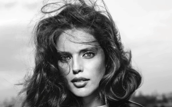 Black and white HD desktop wallpaper featuring American model and celebrity Emily Didonato with tousled hair and a direct gaze.
