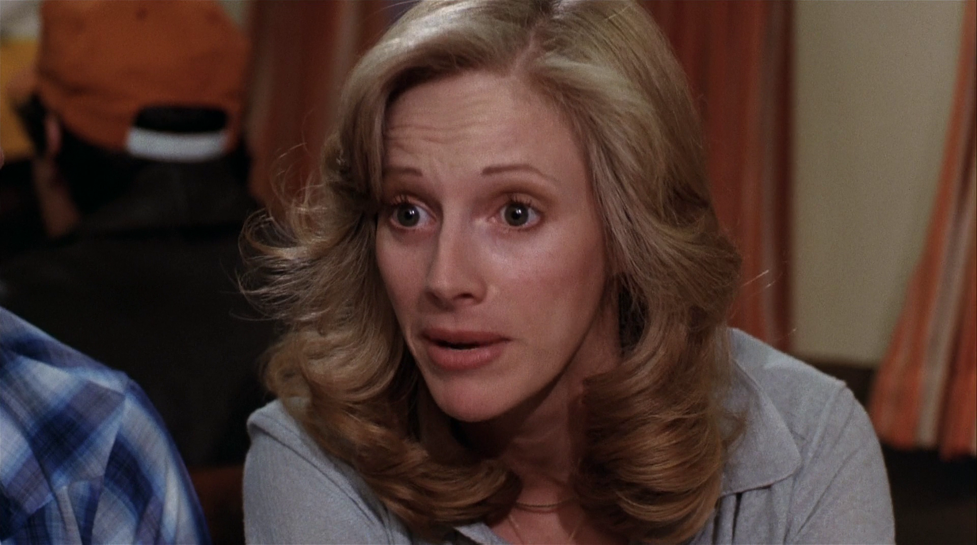 HD PC desktop wallpaper: close-up of a blonde woman with wavy hair and a surprised expression, scene from the movie Every Which Way But Loose.