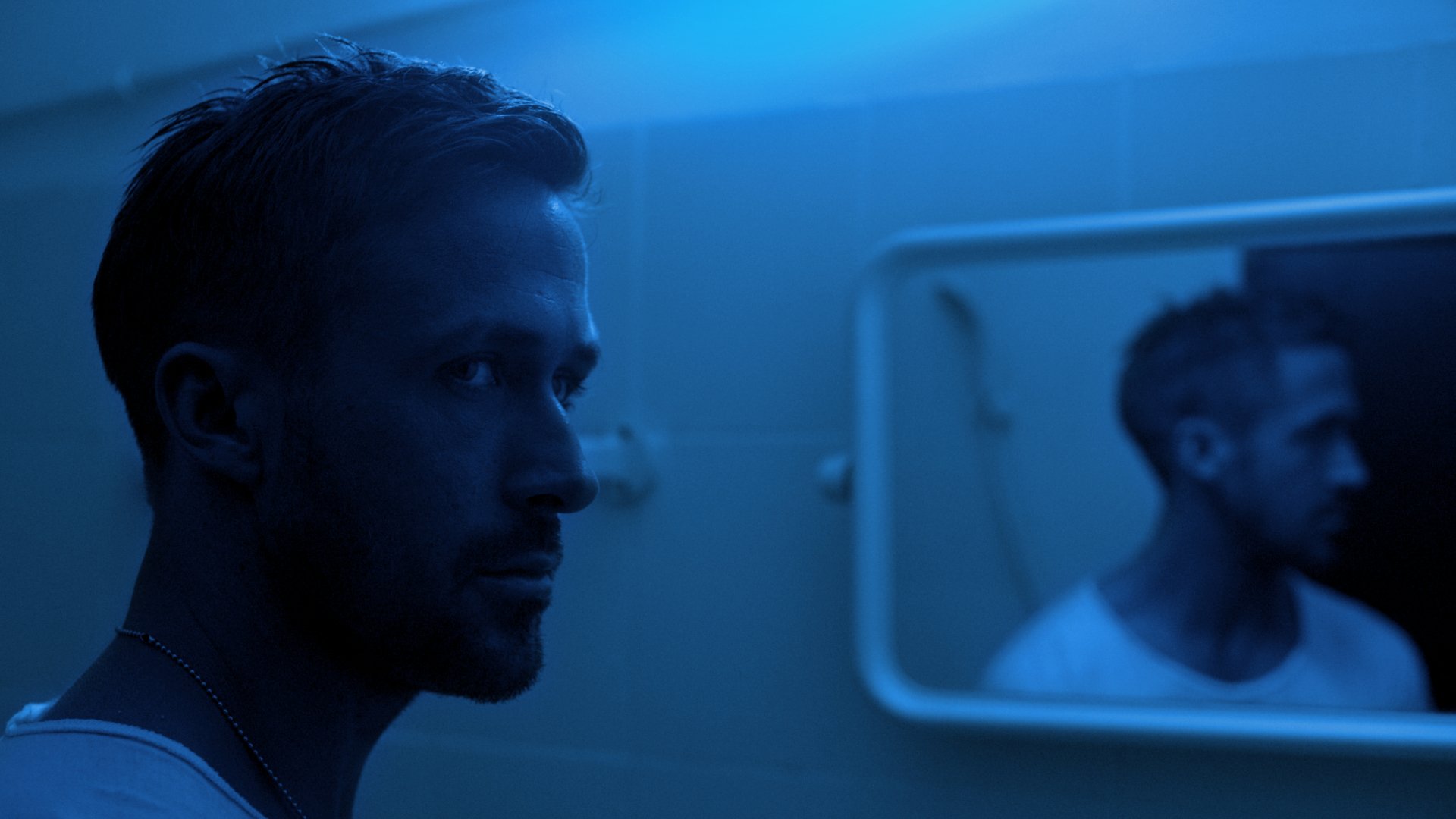 4K Ultra HD PC desktop wallpaper: blue‑lit, moody portrait of a man by a bathroom mirror, cinematic scene evoking the film Only God Forgives.