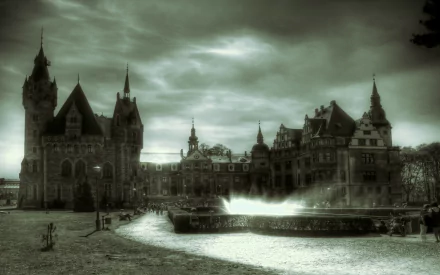 HD desktop wallpaper depicting the man-made Moszna Castle under a dramatic, cloudy sky with a winding path and fountain in the foreground.
