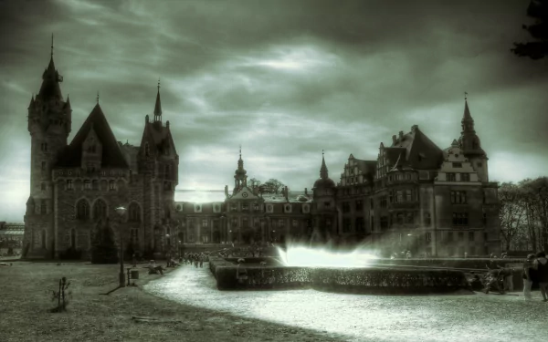 HD desktop wallpaper depicting the man-made Moszna Castle under a dramatic, cloudy sky with a winding path and fountain in the foreground.