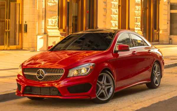 Red Mercedes-Benz CLA-Class vehicle parked on a sunlit city street, presented as an HD PC desktop wallpaper and background.