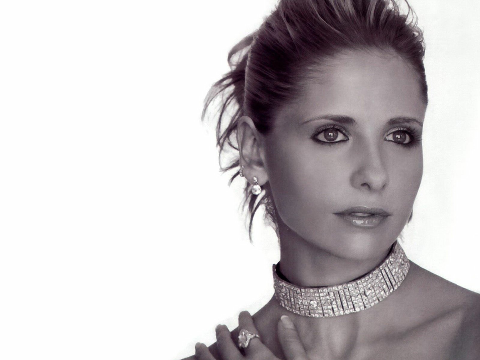 Black and white HD desktop wallpaper featuring a close-up portrait of celebrity Sarah Michelle Gellar wearing a sparkling choker necklace.