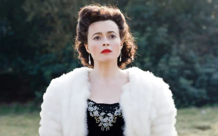 HD desktop wallpaper featuring English actress and celebrity Helena Bonham Carter wearing a white fur coat and black embellished dress outdoors.