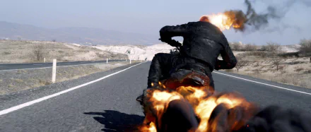 HD PC desktop wallpaper from the movie Ghost Rider: Spirit of Vengeance, featuring Ghost Rider riding a flaming motorcycle down a deserted road.